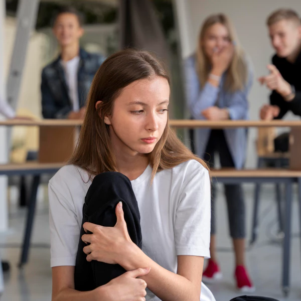 A teenager is being bullied by her classmates.